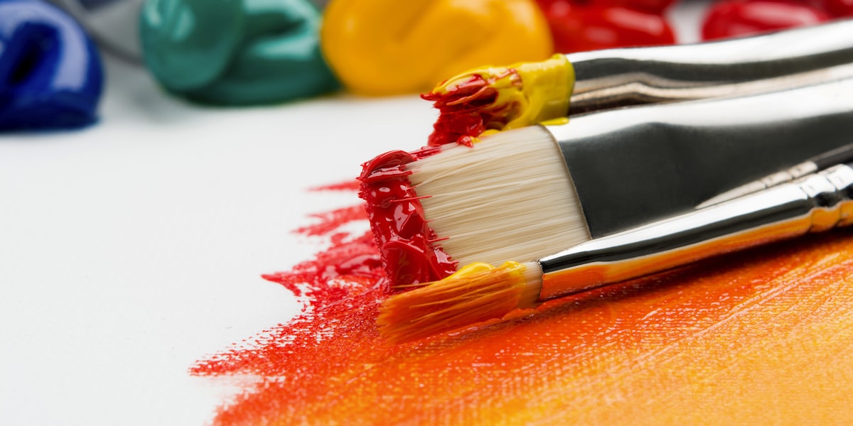 Colour swatches and paint samples arranged on a desk for brand design planning