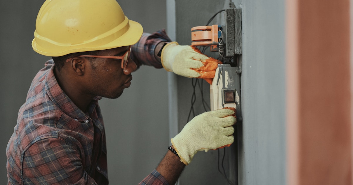 A plumber checking leads on a smartphone between service calls